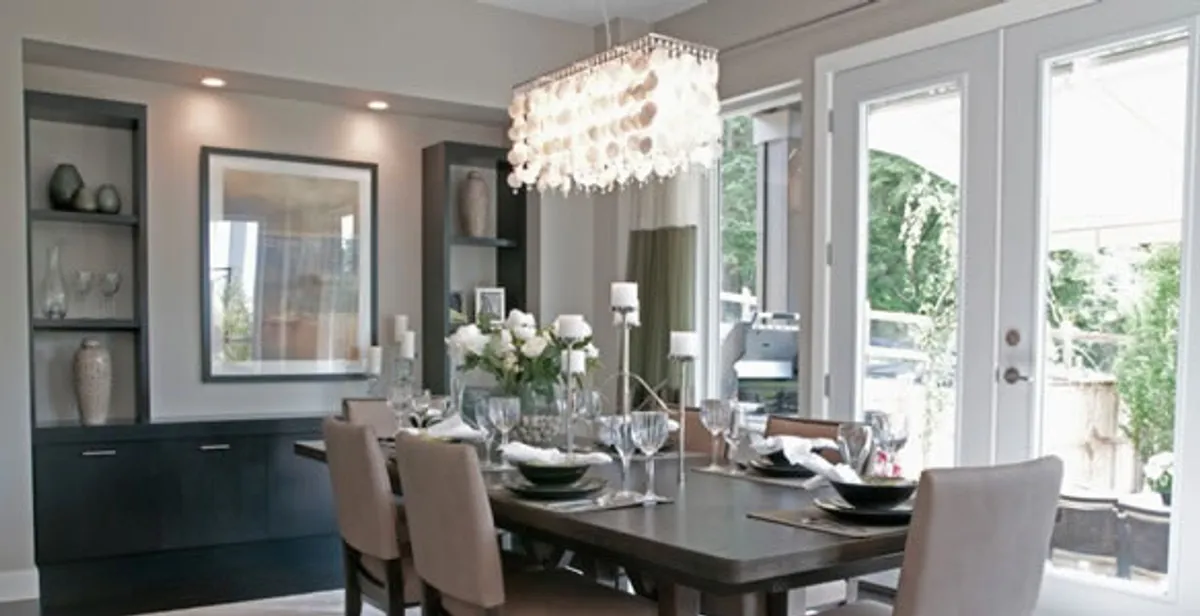 Elegant dining room chandelier installation above table in West Palm Beach, FL