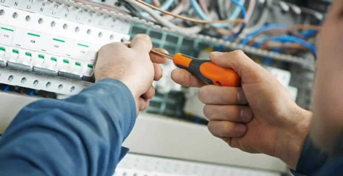 electrical service showing licensed electrician performing electrical panel maintenance and adjustments in West Palm Beach, FL