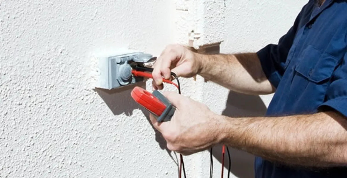 Electrician performing home electrical outlet and wiring inspection in West Palm Beach, FL