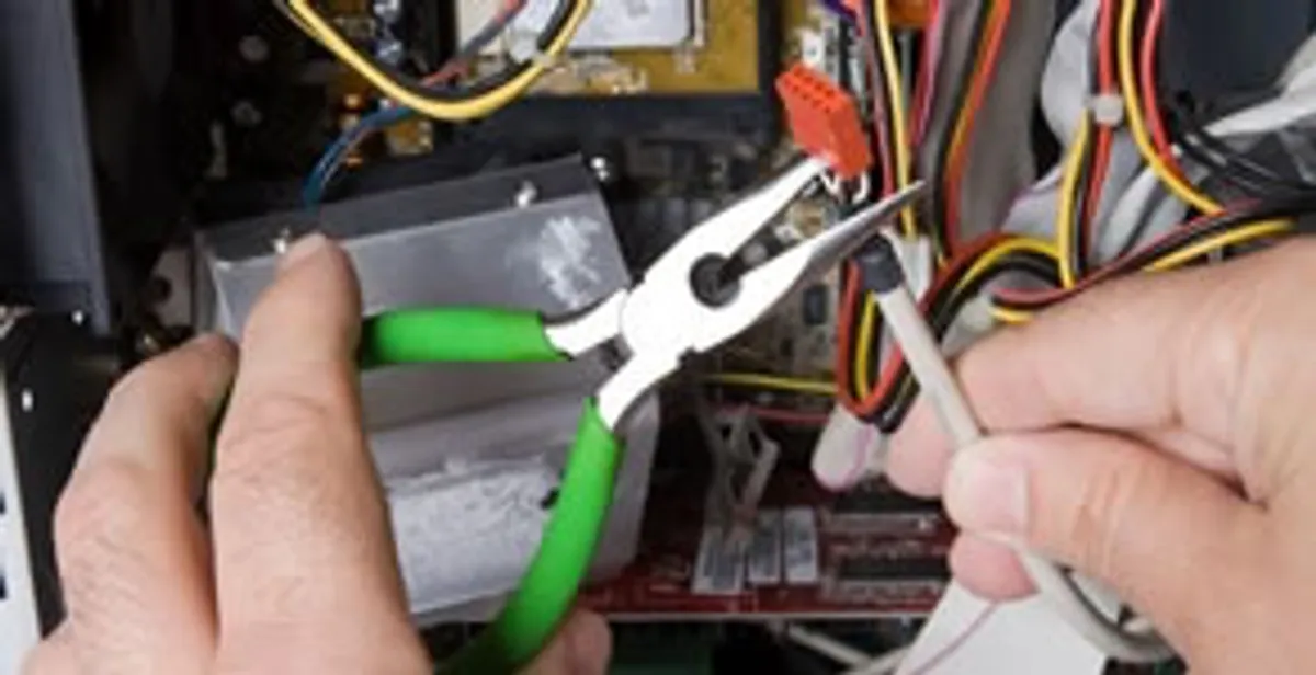 Licensed electrical contractor performing electrical repair with tools in Jupiter, FL