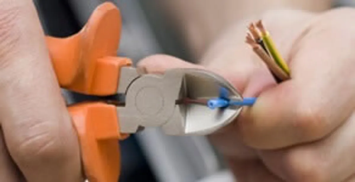 professional electrical services showing precise wire cutting by licensed electricians in West Palm Beach, FL