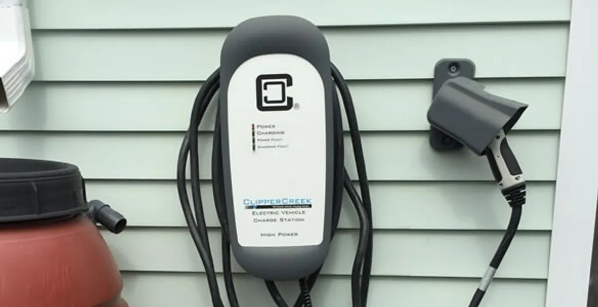 Outdoor electric vehicle charger installation on residential wall in West Palm Beach, FL